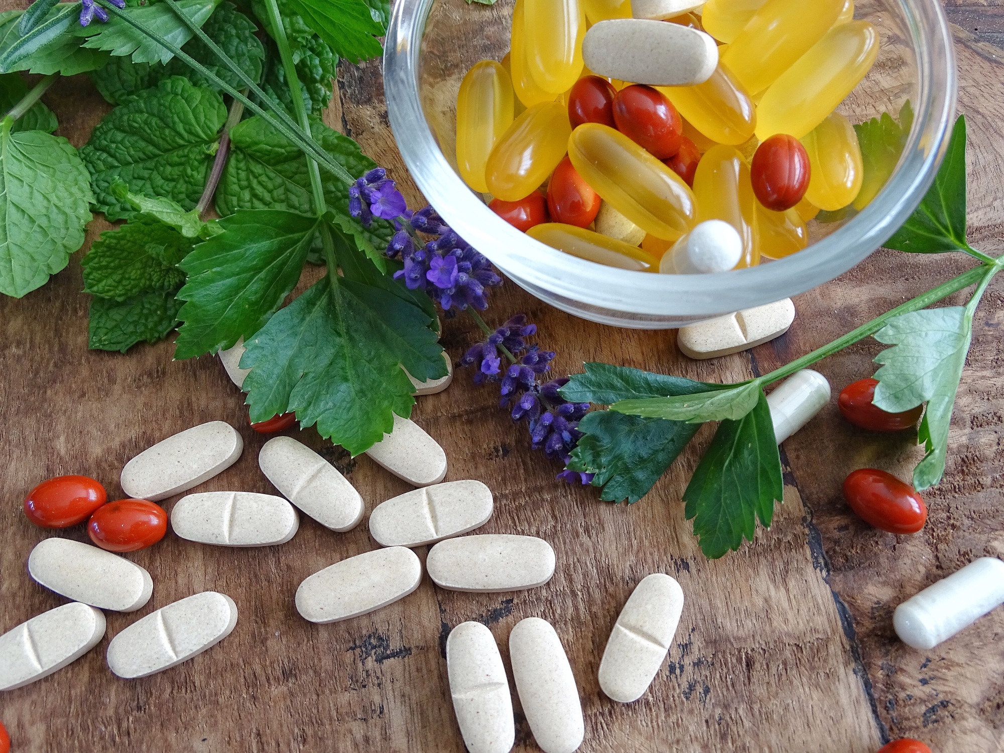 Bowl with multi vitamins, supplements, omega 3 capsules and pills