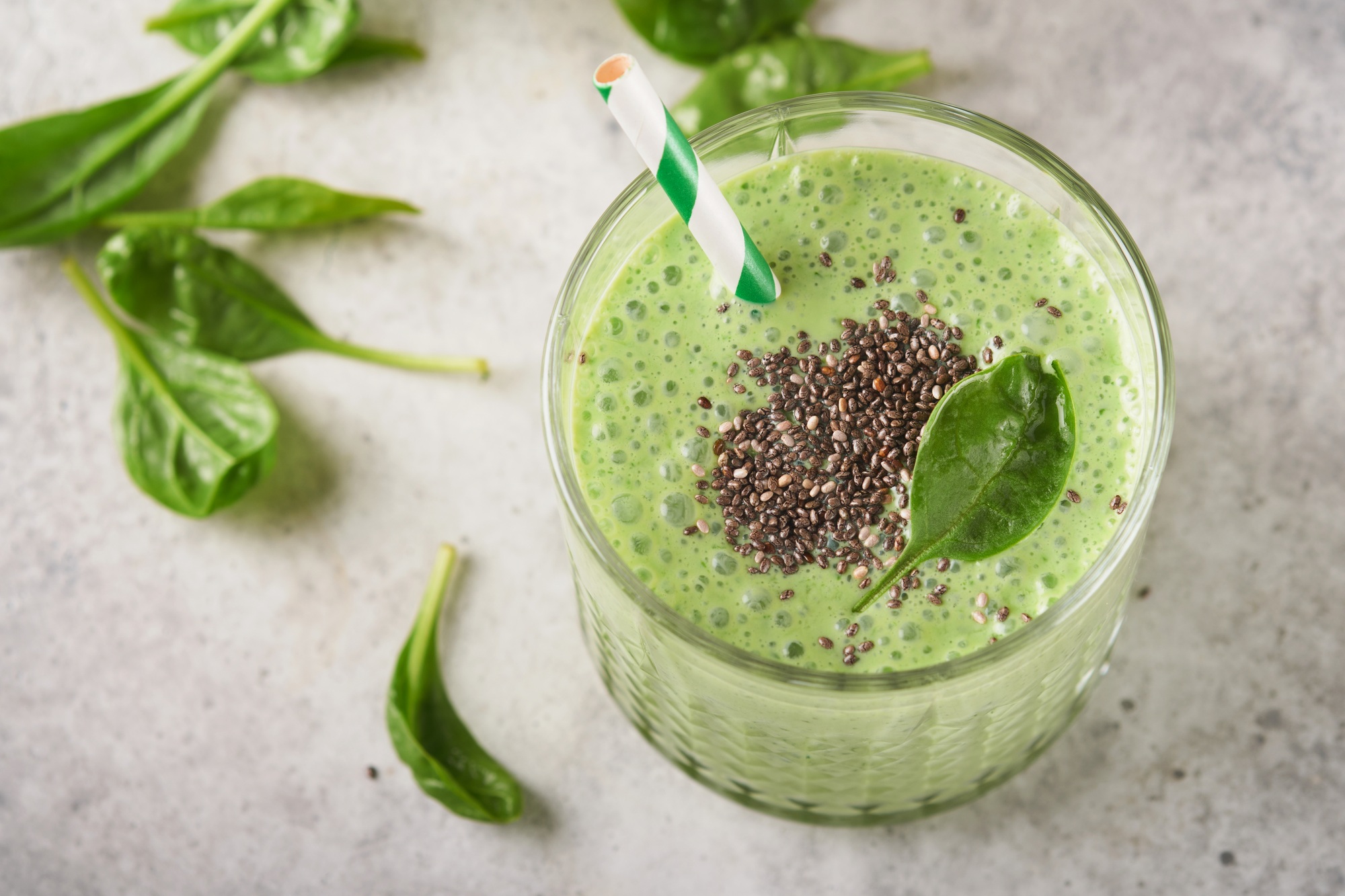 Spinach smoothie healthy green. Vegan smoothie or milkshake from spinach, banana and chia seeds on g
